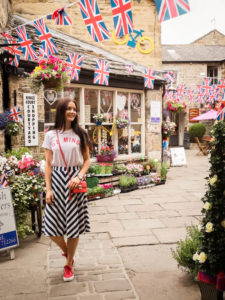 Young woman stood under bunting flags